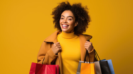 Wall Mural - Beautiful attractive smiling woman holding shopping bags posing on yellow background