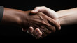 © Sudarshana - White and black hands shake in black color background