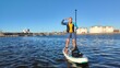 A paddle boarder sails on a sup board in the port of St. Petersburg.