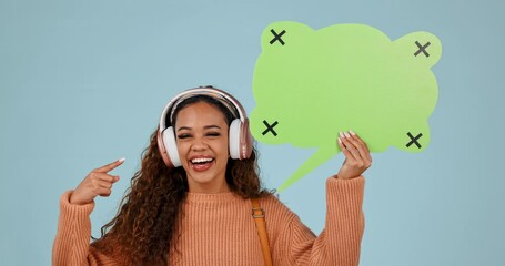 Sticker - Pointing, speech bubble and woman with headphones in studio for voice, music or social media.Young person with announcement, wow review and streaming faq on a blue background with tracking markers