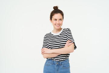 Image of young confident woman in casual outfit, looking happy, standing against white background