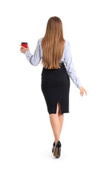 Sticker - Young businesswoman with cup of coffee walking forward on white background, back view