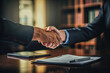 Handshake between an attorney and a client in a law firm office