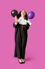 Sticker - Young woman dressed for Halloween as nun with balloons on color background