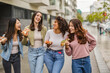 © PintoArt - group of multiracial generation z friends, in the city eating pizza on the street, takeaway, happy teenagers on the weekend