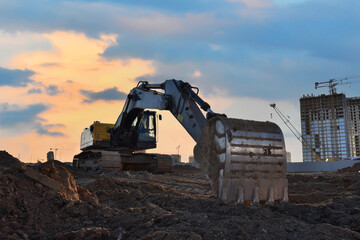 Poster - Excavator dig ground at construction site. Dig foundation. Construction of residential buildings and renovation. Earthmover on groundwork. Excavator on earthmoving. Loader on dredging and trenching.