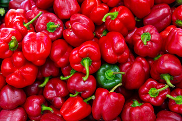 Wall Mural - Closeup of ripe red and green bell peppers on the farmer's market