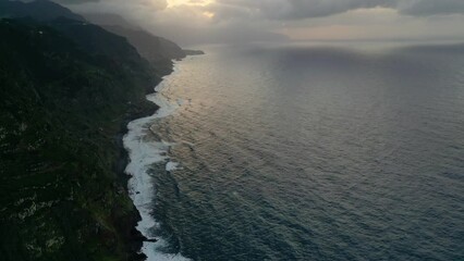 Wall Mural - Beautiful aerial sunset footage in Penha d'Águia rocks and local villages area one of Madeira's most outstanding geological symbols