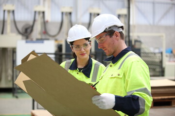 Wall Mural - worker or engineer working in factory with safety uniform , safety hat and safety glasses , image is safety concept or happy workplace