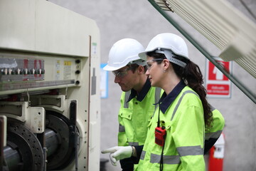 Wall Mural - worker or engineer working in factory with safety uniform , safety hat and safety glasses , image is safety concept or happy workplace