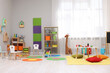 © New Africa - Child`s playroom with different toys and furniture. Cozy kindergarten interior
