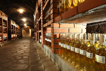 Wall Mural - Beregove, Ukraine - June 23, 2023: Many bottles of alcohol drinks on shelves in cellar