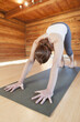 © Designpics - Woman Practices The Yoga 'downward Dog' Position At Indoor Studio, Homer, Alaska