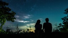 Silhouette Couple Looking The Moon In The Sky At Night
