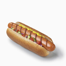 Hot Dog With Mustard And Vegetables On A White Background; Toronto, Ontario, Canada