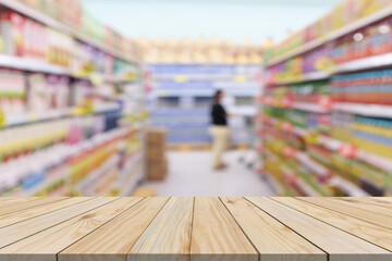 Wall Mural - Empty wood table top with supermarket blurred background for product display