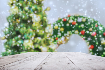 Wall Mural - Empty wood table top with blur Christmas tree with bokeh light background