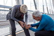 Senior adults jogging at the end of the day in sportsware on the bridge