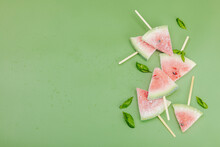 Frozen Watermelon Popsicles On Trendy Savannah Green Background. Refreshing Summer Dessert