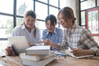 © wichayada - Asian College groups of students using laptop, tablet, studying together with notebooks documents paper for report near windows in classroom. Happy young study for school assignment, Soft focus