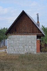 Canvas Print - one white gray brick rustic barn with brown wooden loft outside