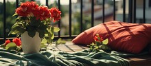 A Balcony Displays A Green Blanket And A Pot With Red Flowers