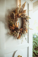 Close-up Of An Autumn Wreath Hanging On An Open Front Door