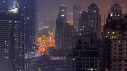 Wall Mural - Dubai Marina and Media City districts with modern skyscrapers and office buildings aerial all night timelapse.