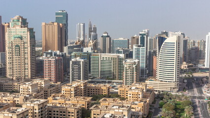 Wall Mural - Skyscrapers in Barsha Heights district and low rise buildings in Greens district aerial all day timelapse. Dubai skyline