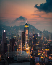 Aerial view of Hong Kong skyline with financial area skyscrapers at sunset.