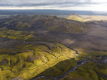 Aerial View Of A River Estuary Crossing The Valley With Mountain In Background, Kirkjubaejarklaustur, Southern Region, Iceland.