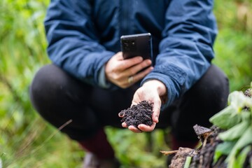 female farmer taking a soil sample from a crop on a farm in australia