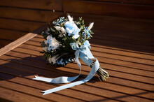 Wedding Bouquet With Flowers On Wooden Background