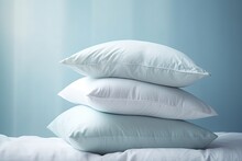 A Set Of Soft, Clean Pillows Are Neatly Folded On The Bed.
