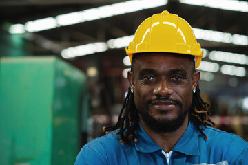 Wall Mural - Close-up. African American worker in factory, maintenance work in modern industrial concept. workers working in factory Professional engineer.