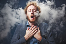 A Man, Furious And In Discomfort, Experiences The Adverse Effects Of Vaping, Coughing And Feeling Dizzy, Highlighting The Problems Associated With This Habit.