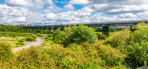 Wall Mural - A view along the side of the Bennerley Viaduct over the Erewash canal in summertime