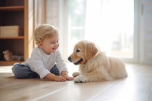 Cute Little Young Blonde Toddler Boy Is Playing With The Puppy On The Floor.