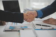 © Phanphen - Business handshake for teamwork of business merger and acquisition,successful negotiate,hand shake,two businessman shake hand with partner to celebration partnership and business deal concept