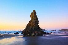 Rock Formations Reflecting In Tide Pools At Low Tide On Bandon Beach At Sunset; Oregon United States Of America