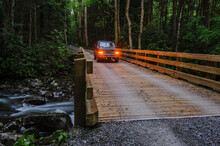 A Vehicle Going Over A River On A Wooden Bridge In Great Smoky Mountains National Park; Tennessee United States Of America