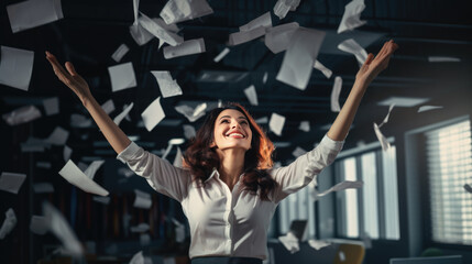 Happy businesswoman throwing papers in the air as a sign of victory and success in her work