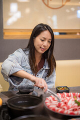 Wall Mural - Woman eat hot pot at restaurant