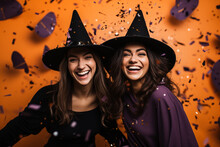Young Women In Halloween Witch Costume On Orange Background With Flying Confetti, Candid