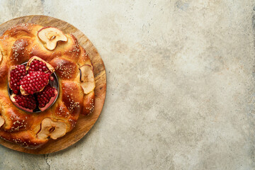 Wall Mural - Jewish Holidays - Rosh Hashanah or Rosh Hashana. Pomegranate, apples, honey and round challah on rustic grey table background. Jewish Autumn celebration. Shana Tova. Yom kippur concept. Top view.