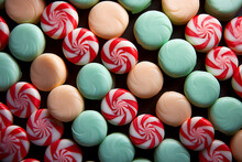 A Close-up Of Colorful Candy Canes Arranged In A Low Relief Pattern Against Peppermint Striped Backgrounds 