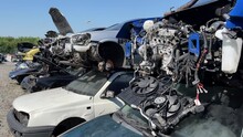 Damage Car In A Junkyard Being Salvage For Car Parts. Vehicle Recycling Industry, Dumping, Dismantling Cars