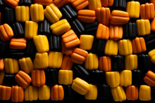 A Close-up Shot Of Candy Corn Patterns In Low Relief On A Black Gradient Background With Empty Space For Text 