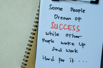 Wall Mural - Concept of Some People Dream of Success While Other People Wake Up and Work Hard For it write on paperwork isolated on Wooden Table.