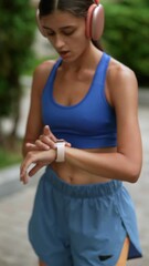 Wall Mural - A young woman in sports clothing is getting her body ready with warm-up exercises before her run.